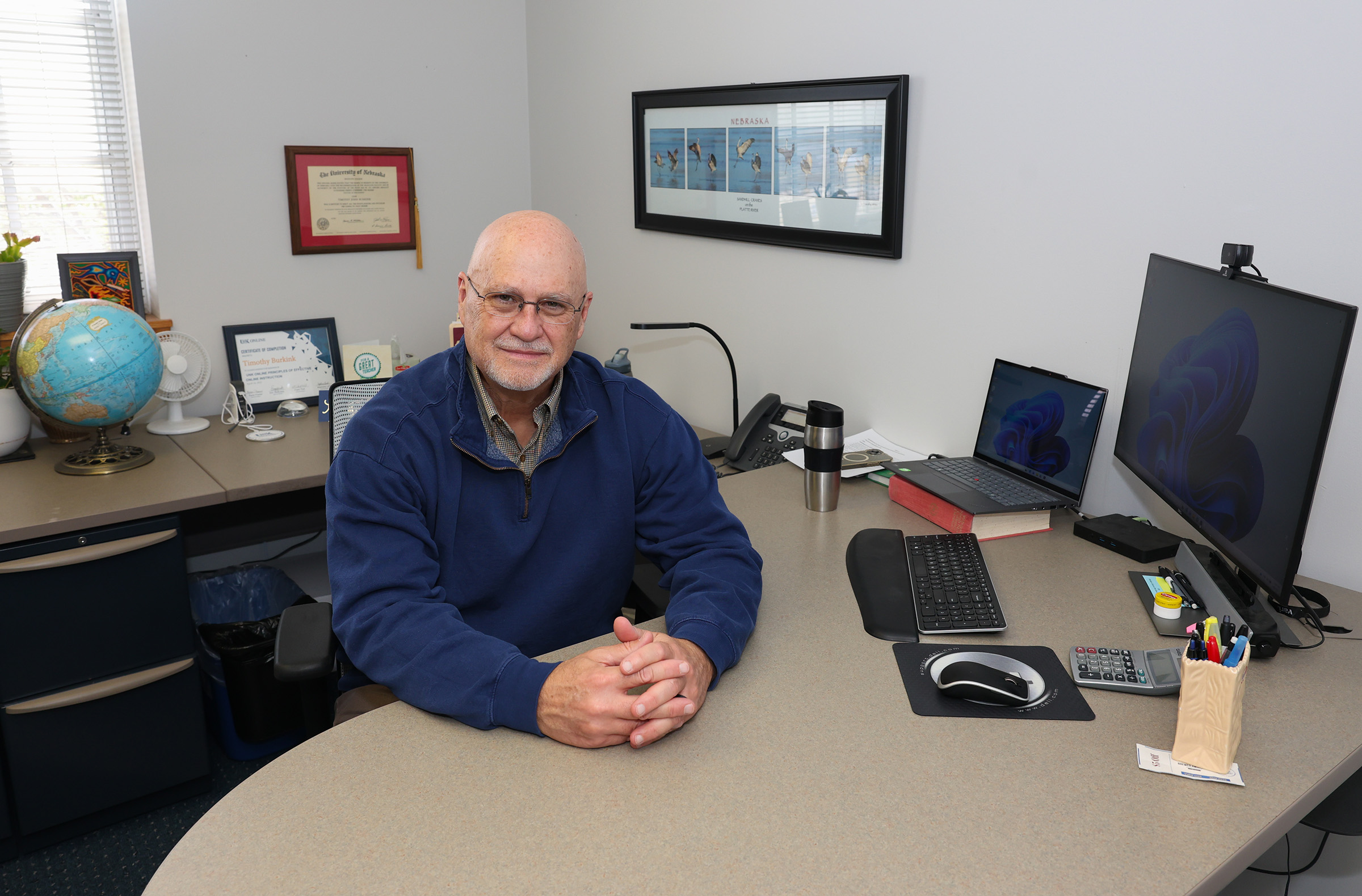 Tim Burkink poses for a photo inside his office at UNK.