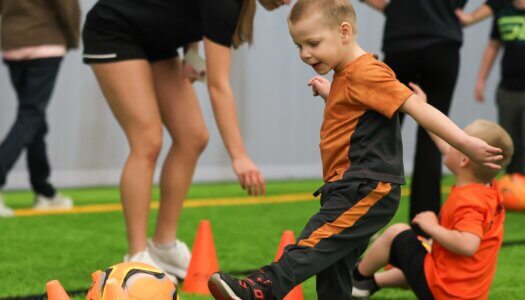 A young boy participating in TOPSoccer.