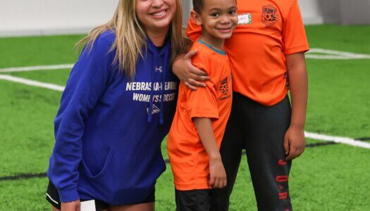 UNK soccer player Daniella Iaquinta poses for a photo with TOPSoccer participants.