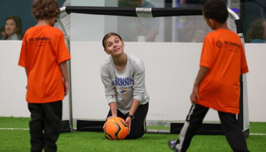UNK assistant coach Haley Chitwood plays a game with TOPSoccer participants.