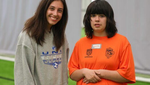 UNK soccer player Hanna Schimmer poses for a photo with a TOPSoccer participant.