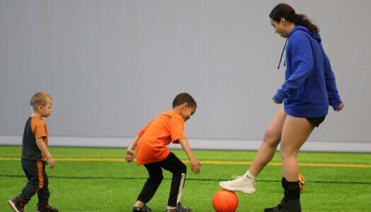 UNK soccer player Serene Hamzeh plays a game with TOPSoccer participants.