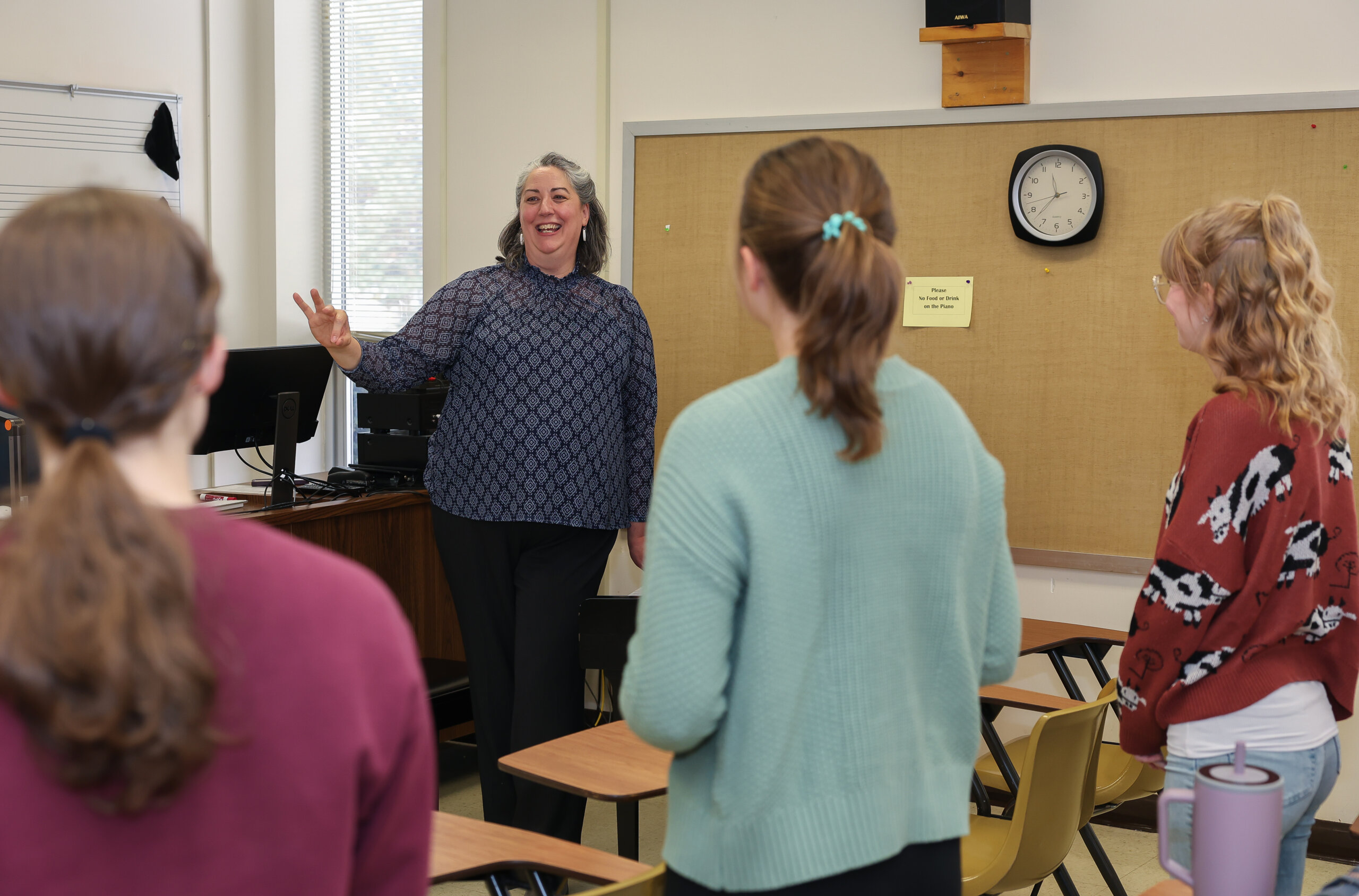 A woman teaches singing.