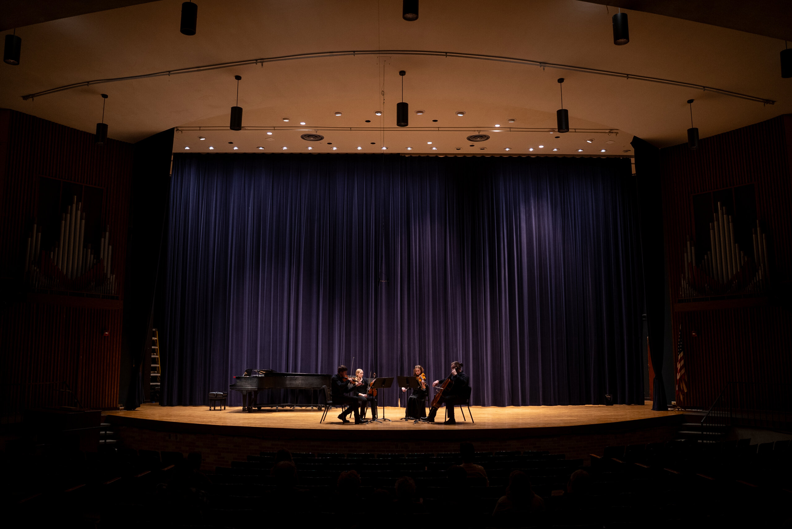 A string quartet plays on a stage.