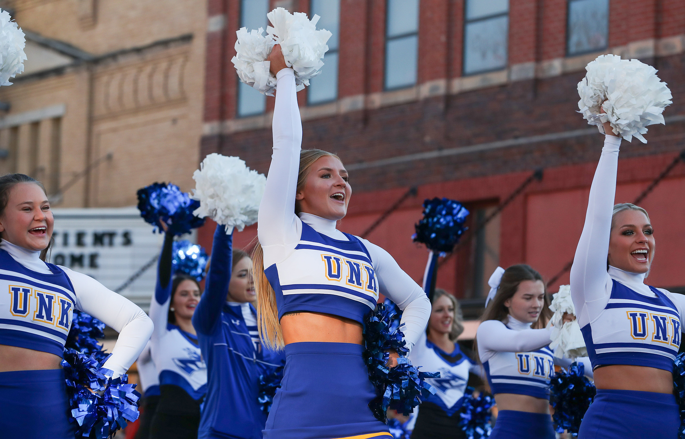 Allie Daro and other members of the UNK cheer team participate in the homecoming parade in 2022.