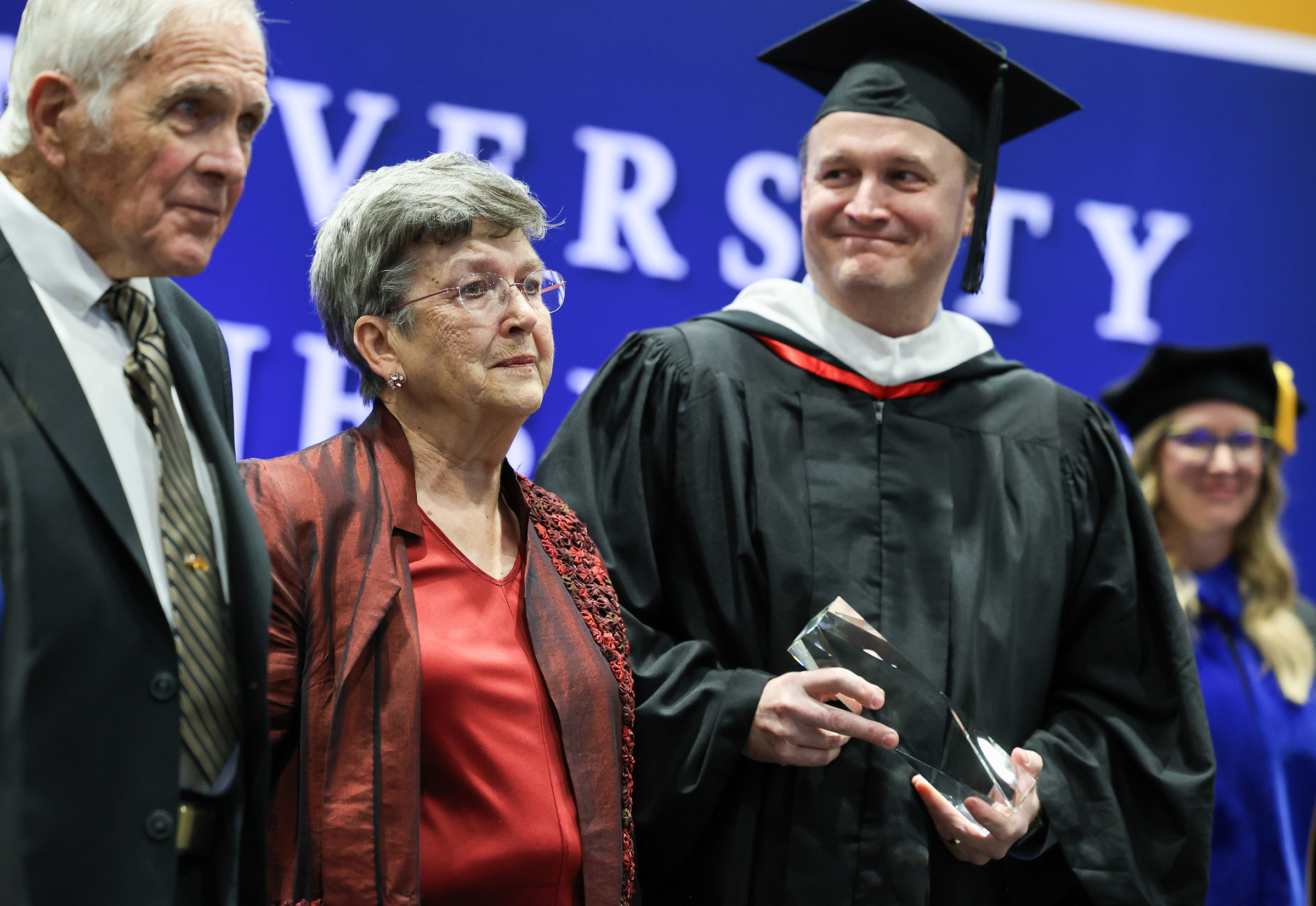 Keith and Eileen Carpenter are recognized with the Ron and Carol Cope Cornerstone of Excellence Award during UNK's spring commencement.