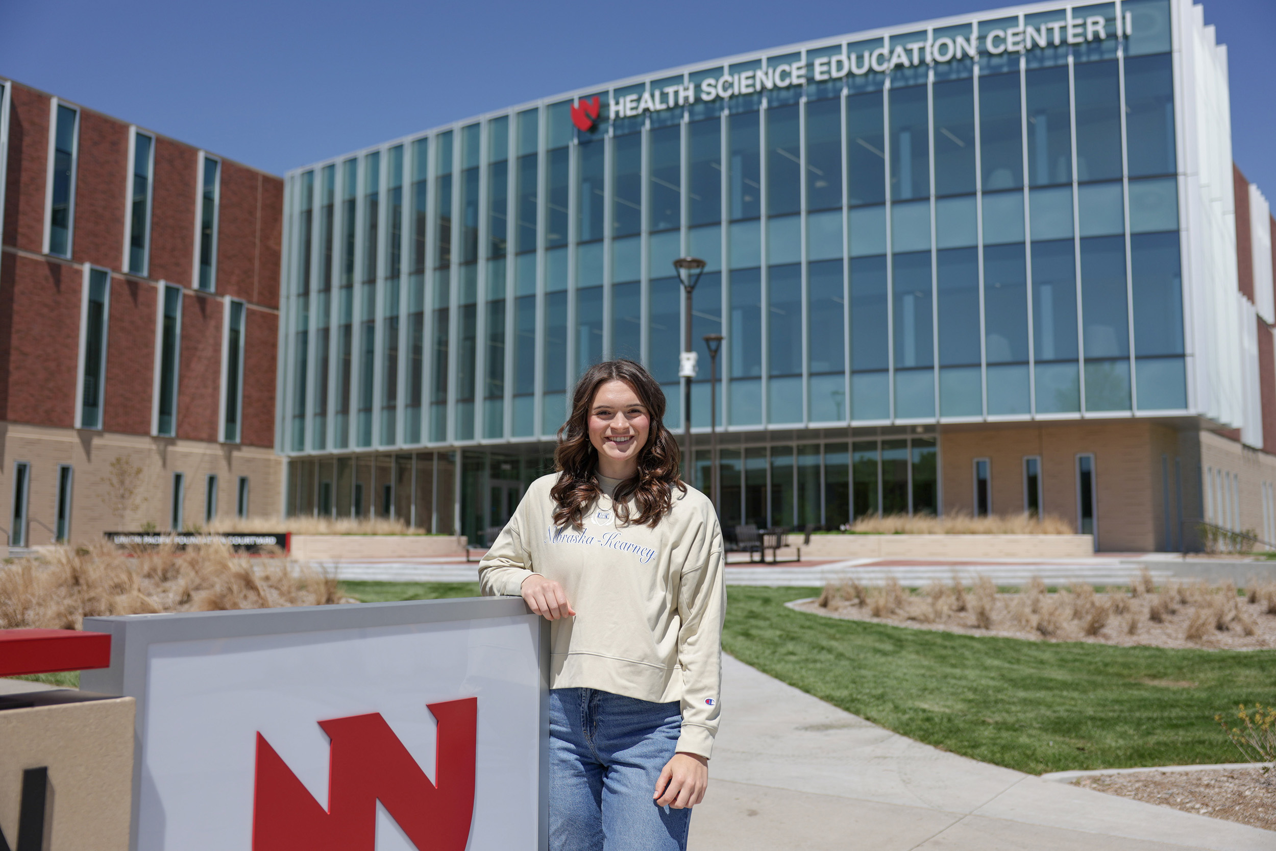 Elly Piper poses for a photo outside the Health Science Education Center II on the UNK campus.