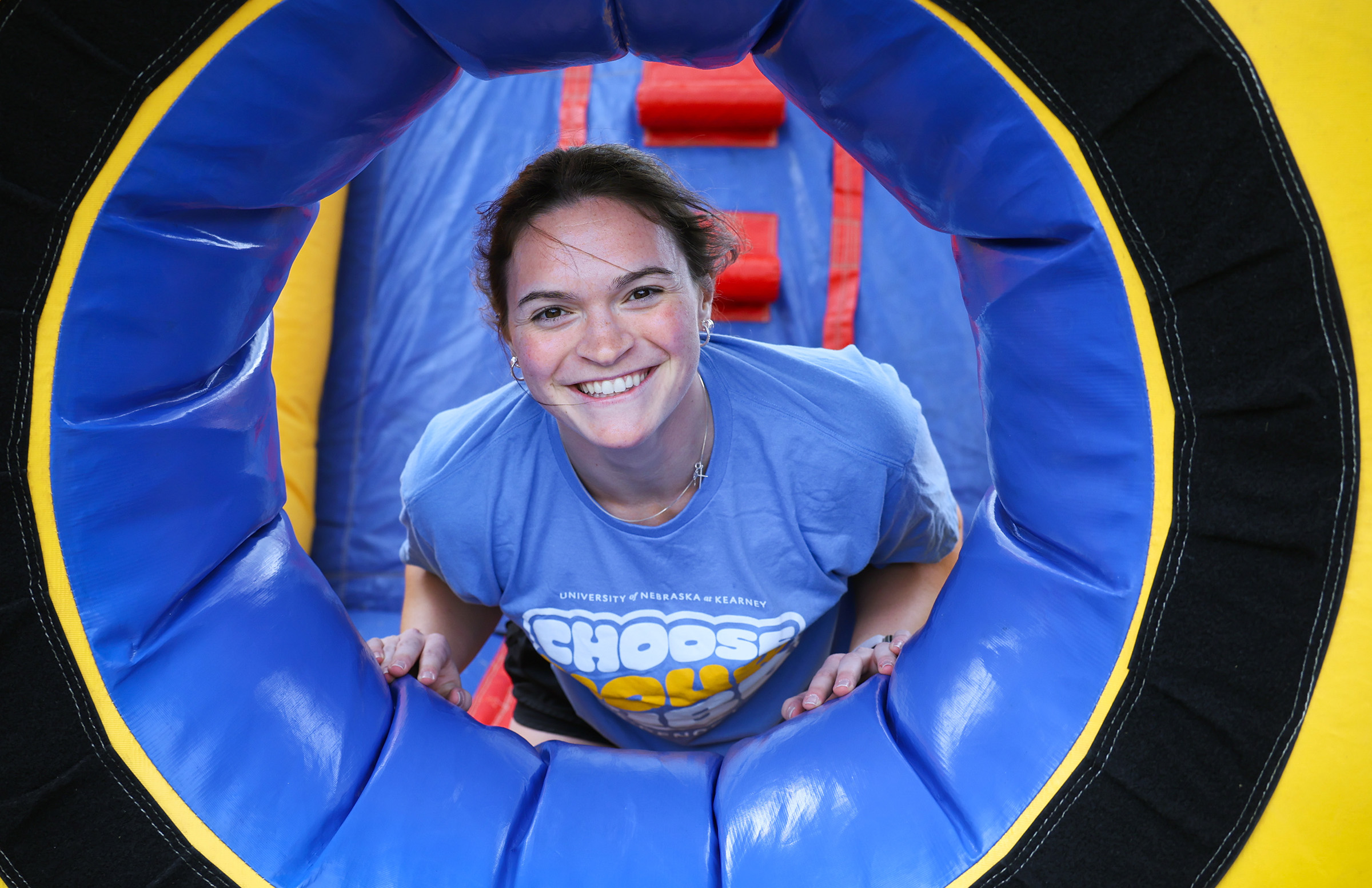 Elly Piper poses for a photo inside an inflatable bounce house during a UNK Residence Life event.