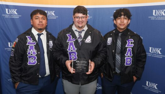 Sigma Lambda Beta with their award.