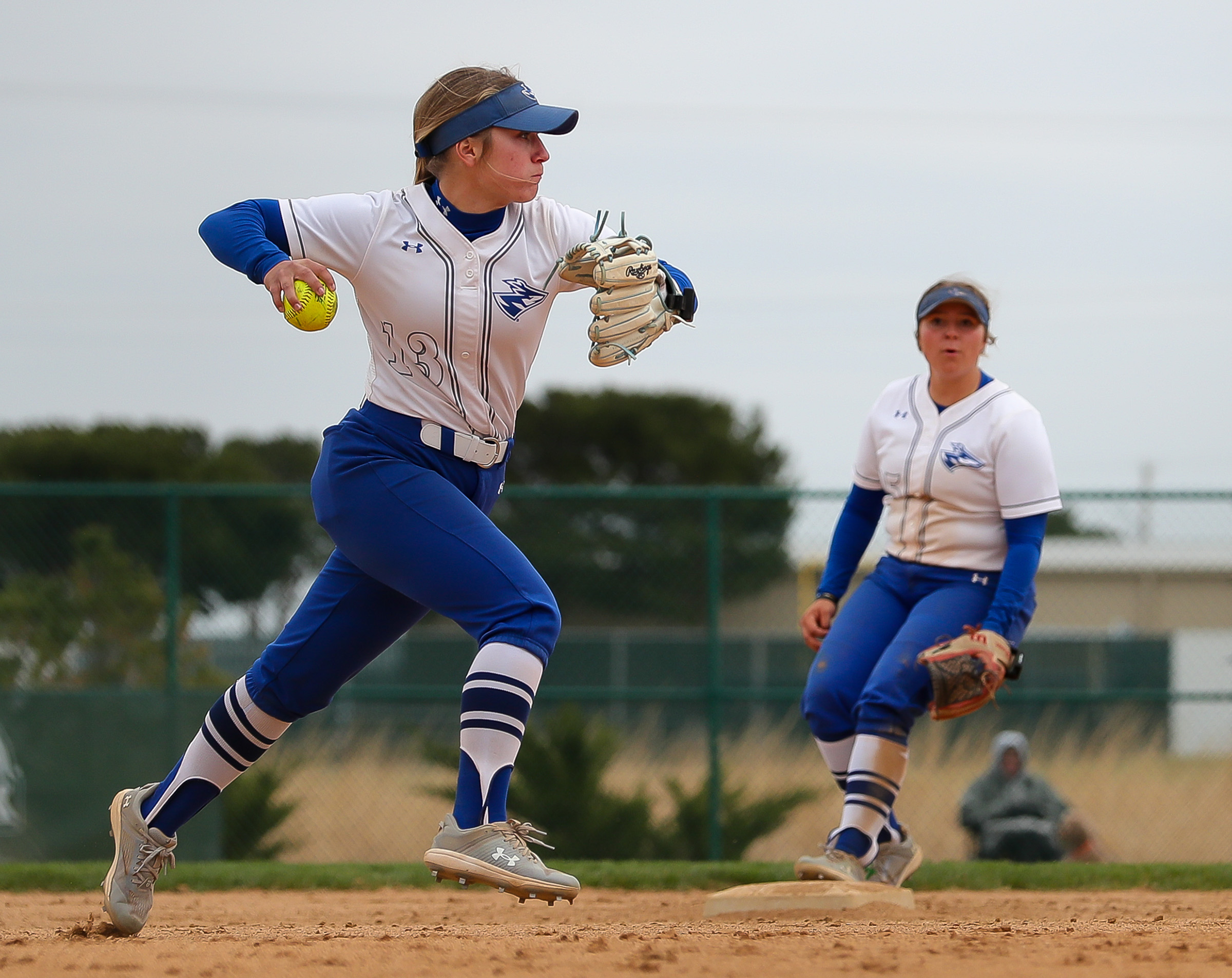 Mary Chvatal makes a throw to first base.