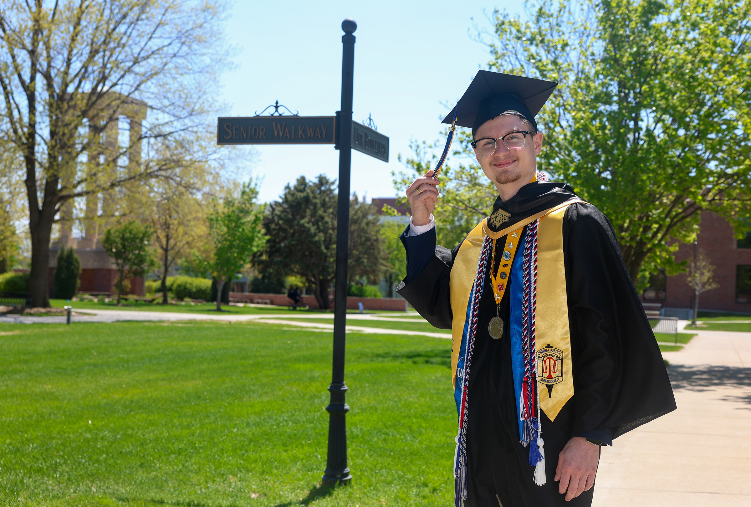 Riley Rose poses for a photo in his commencement regalia.