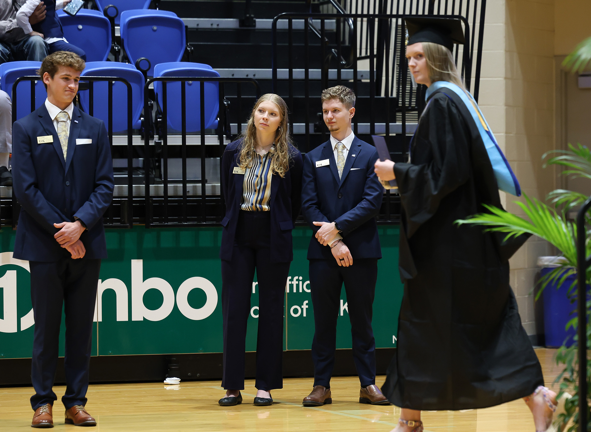 Riley Rose serves as a Chancellor's Ambassador during UNK commencement.