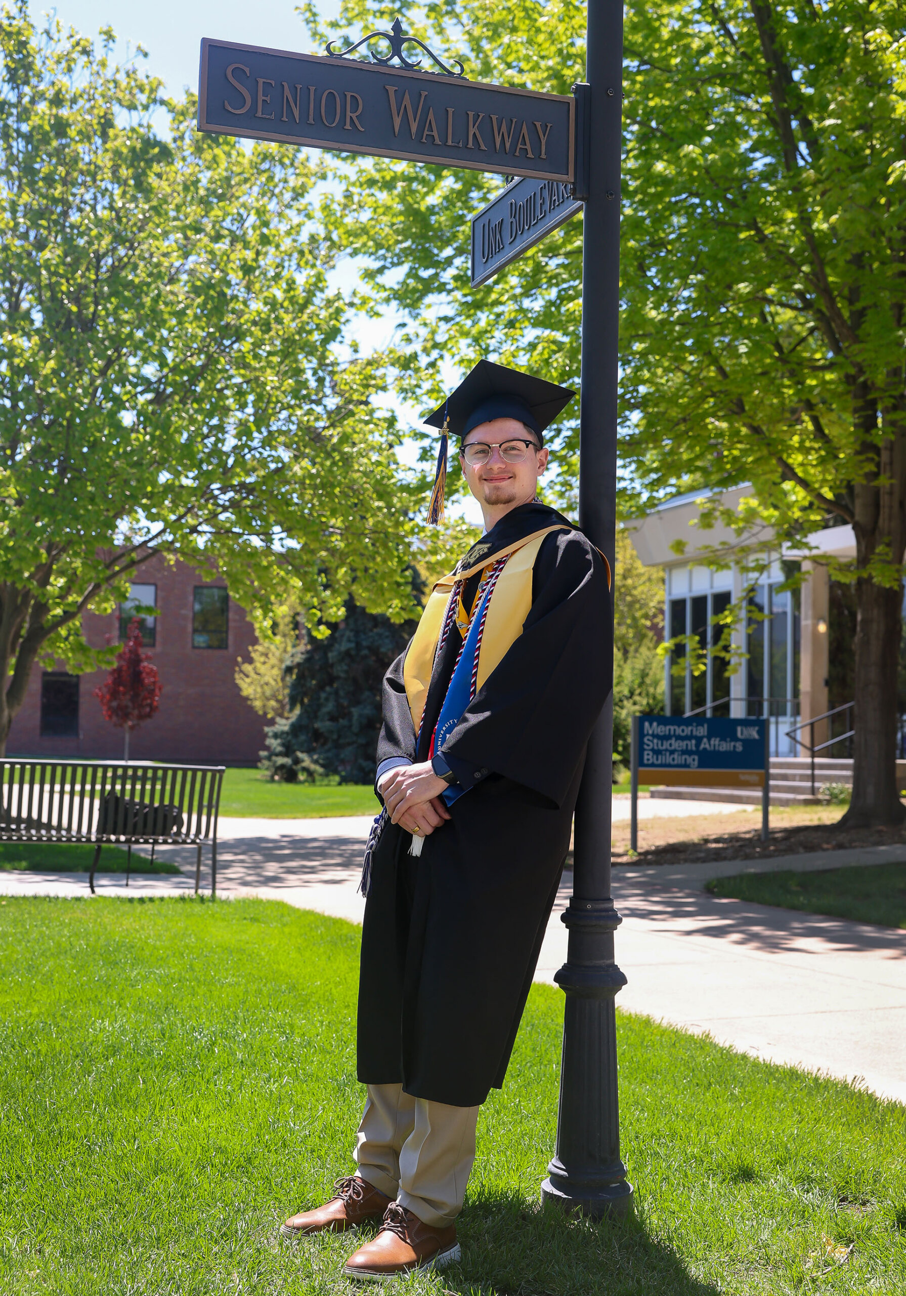 Riley Rose poses for a photo in his commencement regalia.