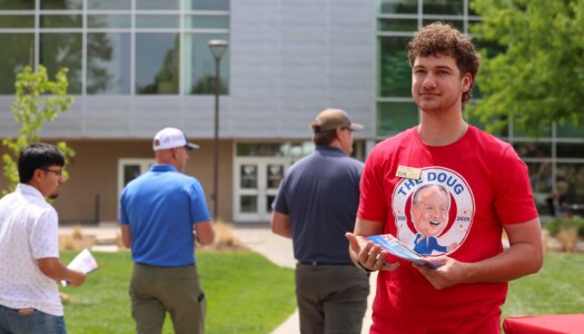Chancellor's Ambassador Jacob Stegman hands out programs during Thursday's event.