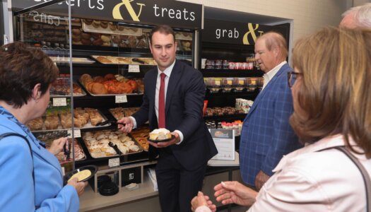 Michael Christen passes out pastries during the Douglas A. Kristensen Rural Health Education Complex grand opening celebration.