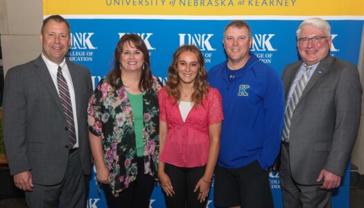 Avery Longshore with her family, KPS Superintendent Jason Mundorf and UNK College of Education Dean Mark Reid.