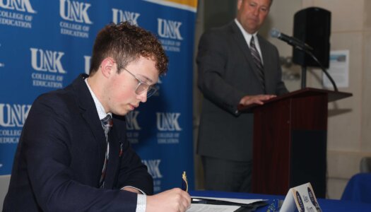Alex Worm accepts the KTOM Scholarship.