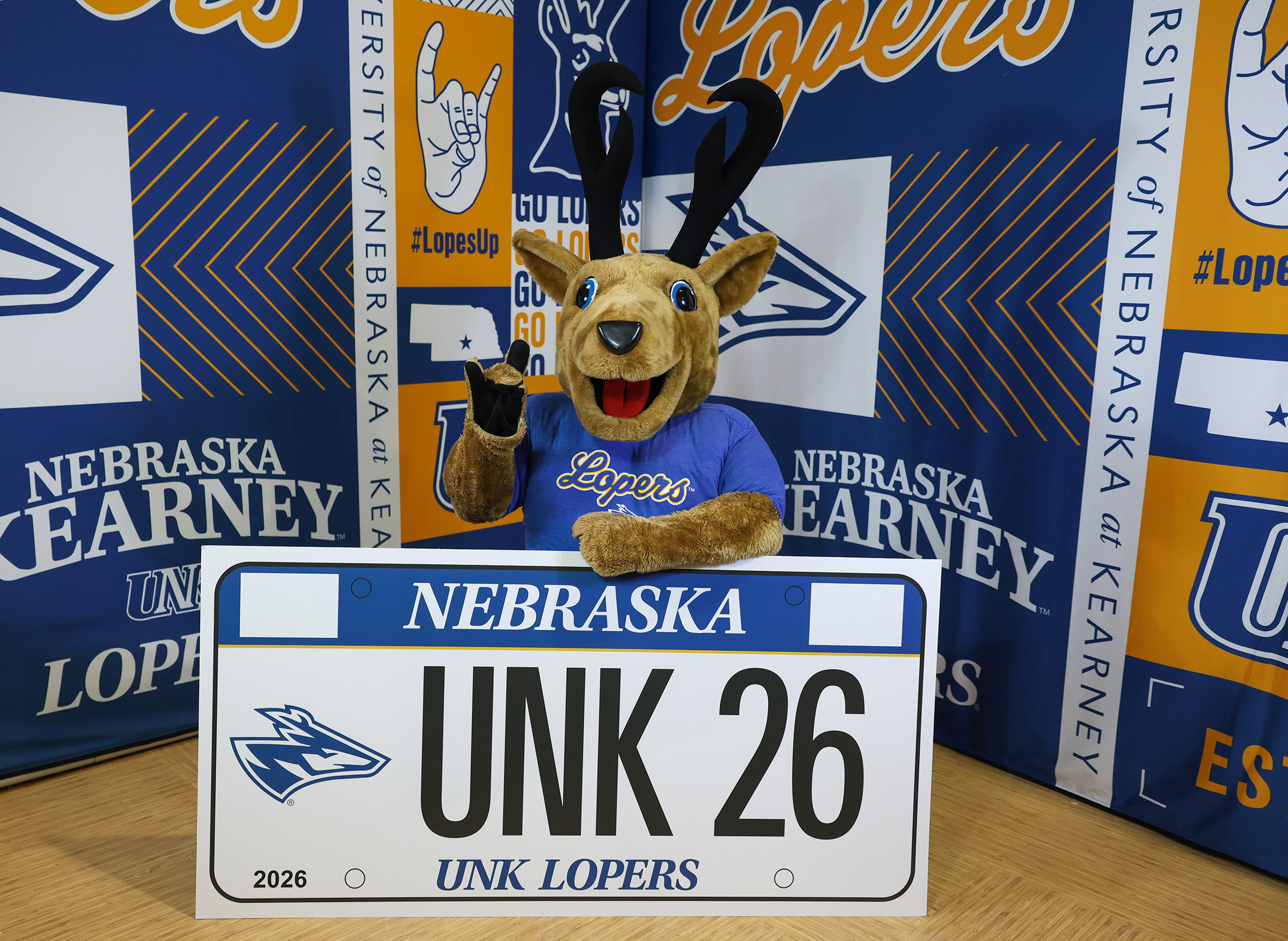 Louie the Loper with an example of the UNK specialty license plates.