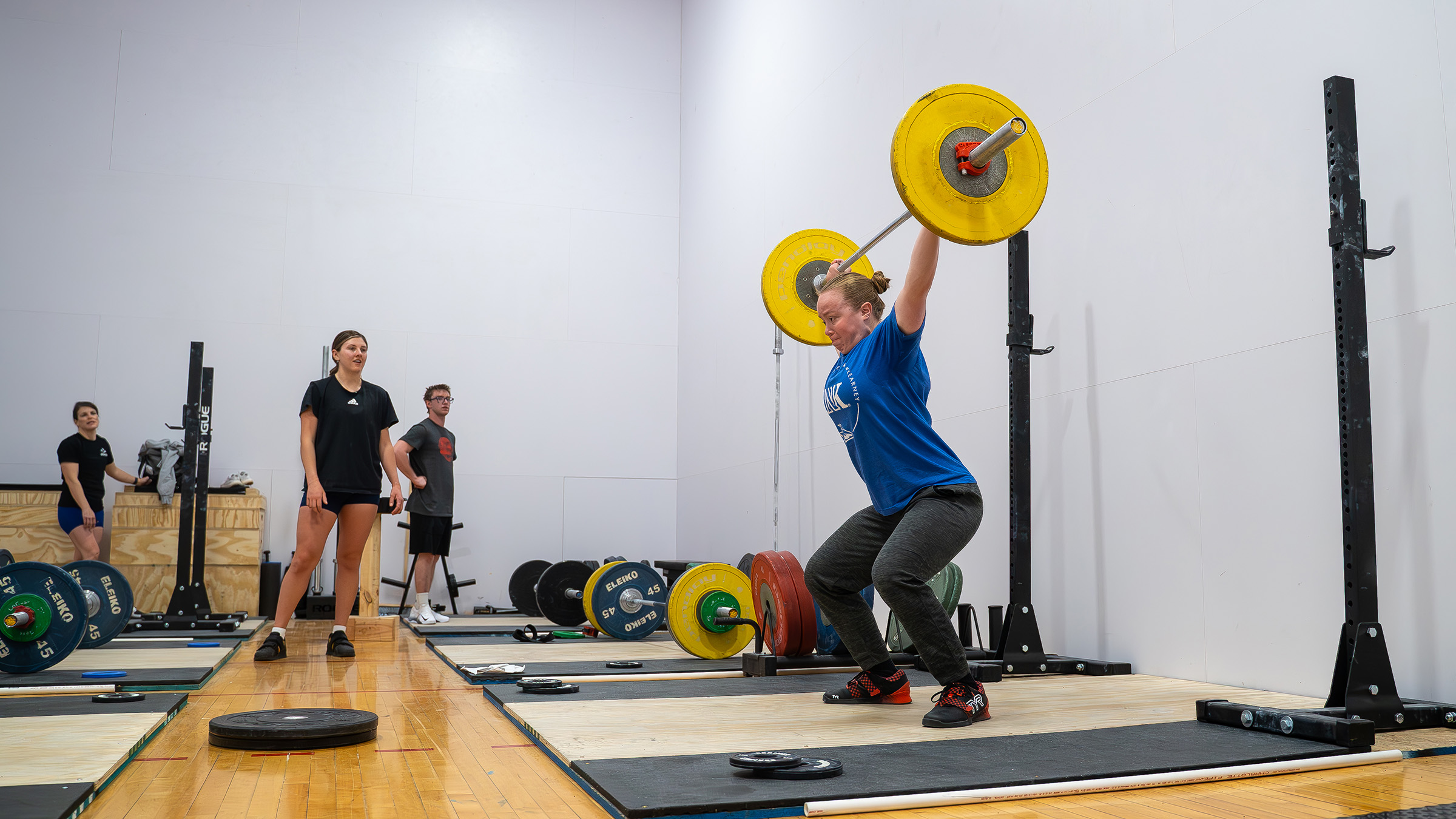 Raeghann Behrens, right, works out with the UNK Weightlifting Club during a recent training session.