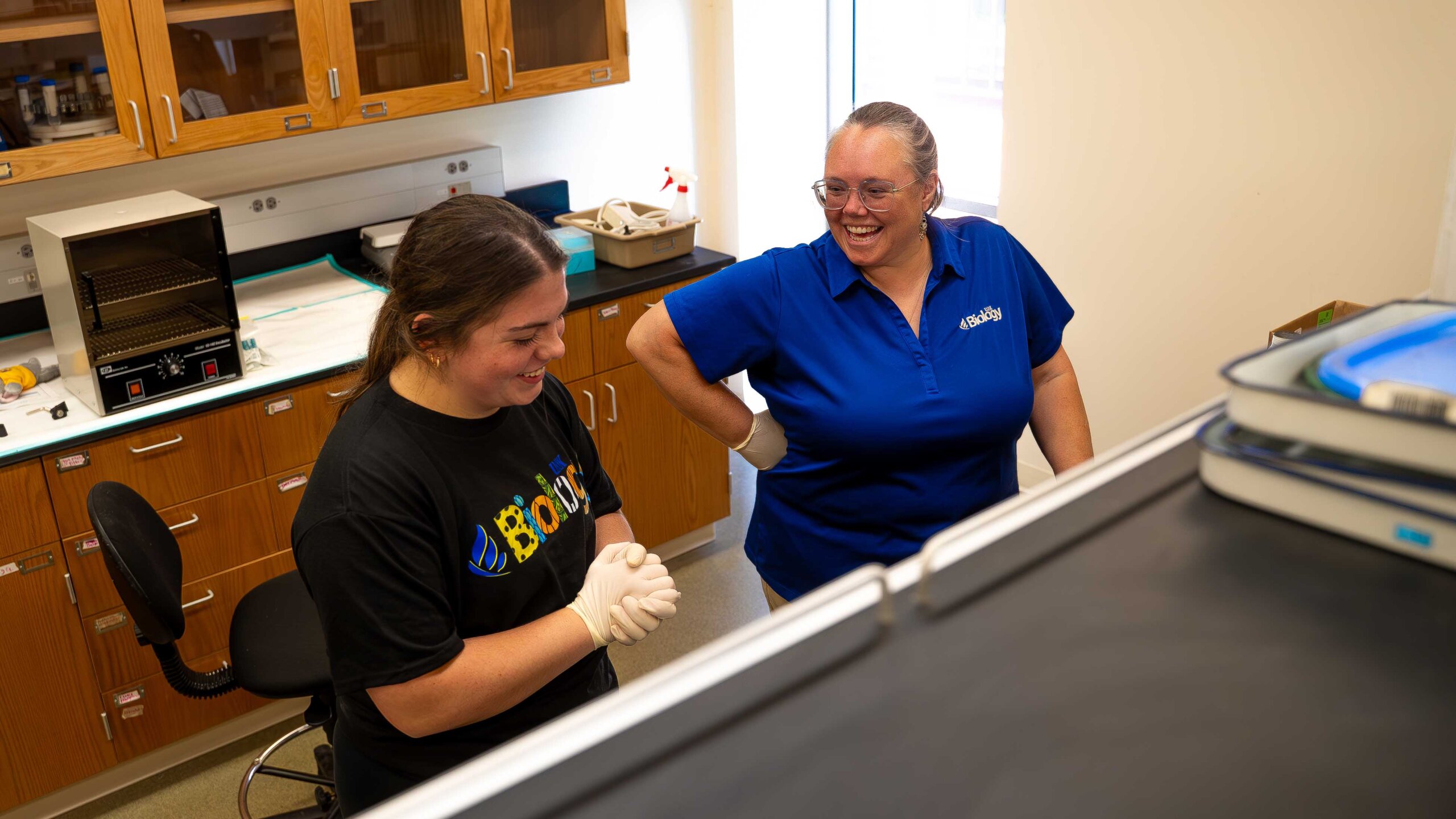 UNK senior Morgan Holm and biology professor Letty Reichart chat while testing blood samples inside a lab at Bruner Hall.