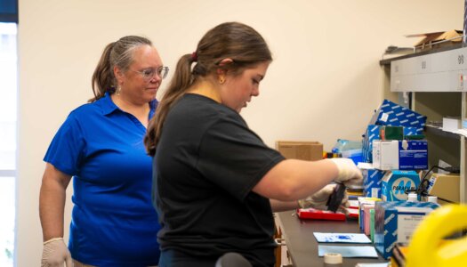 Letty Reichart and Morgan Holm test blood samples.
