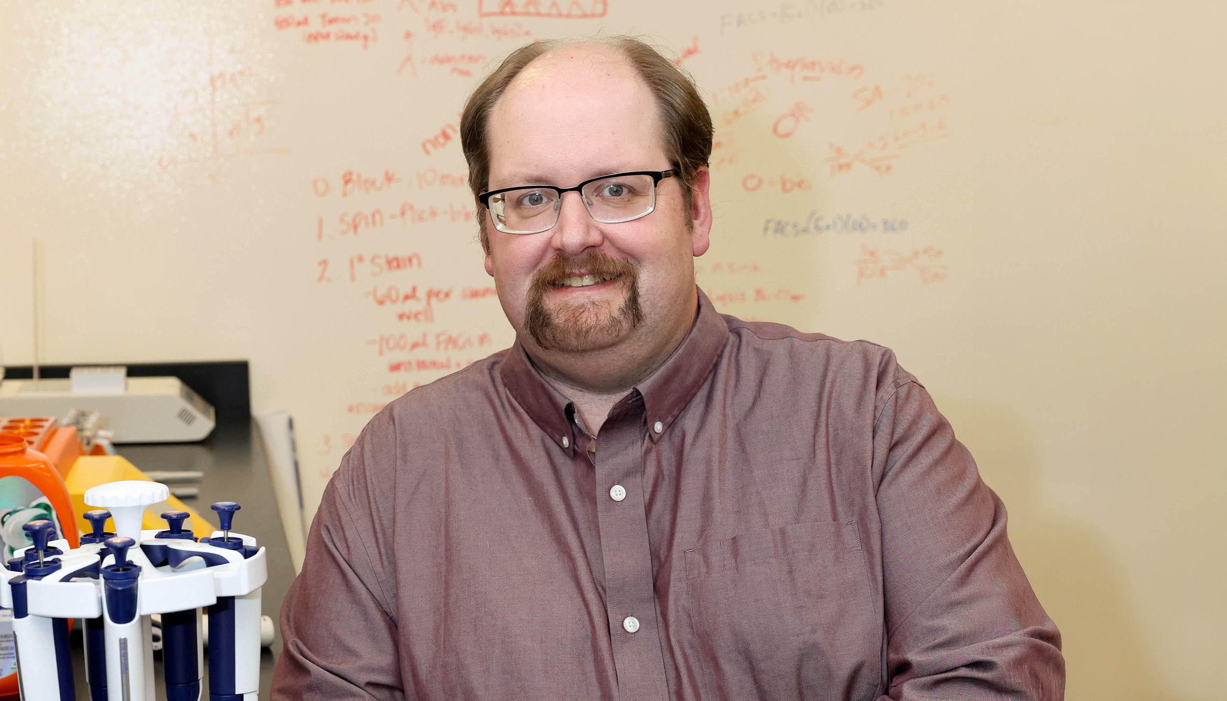 Joe Dolence poses for a photo in his lab.