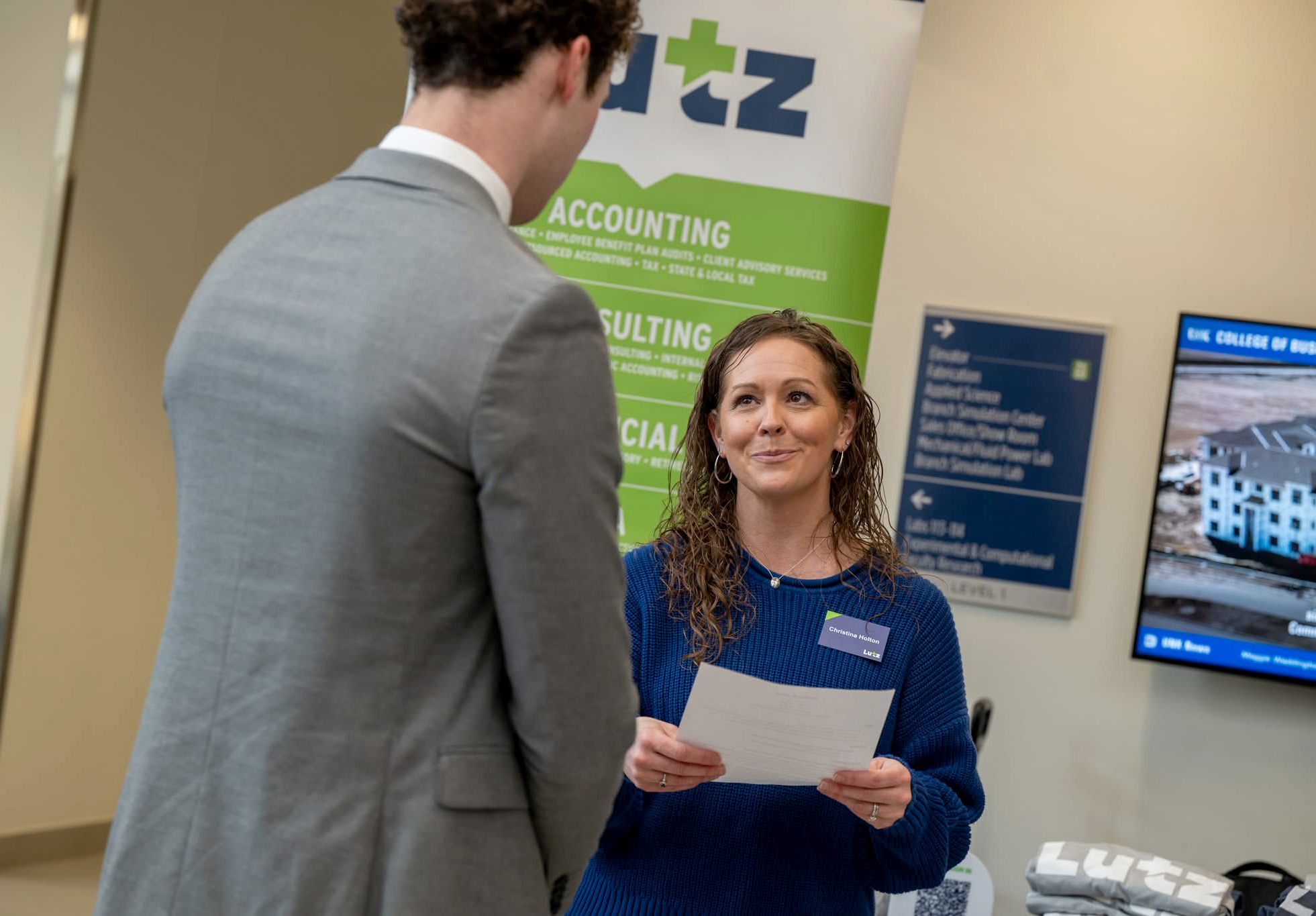 Christina Holton, a corporate recruiter with Lutz, meets with a student during an event hosted by the UNK College of Business and Technology.