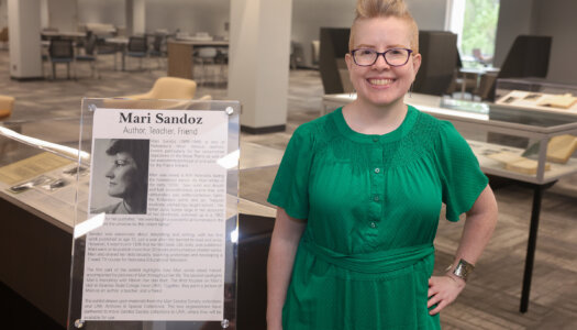 Laurinda Weisse with the Mari Sandoz exhibit at UNK's Calvin T. Ryan Library.