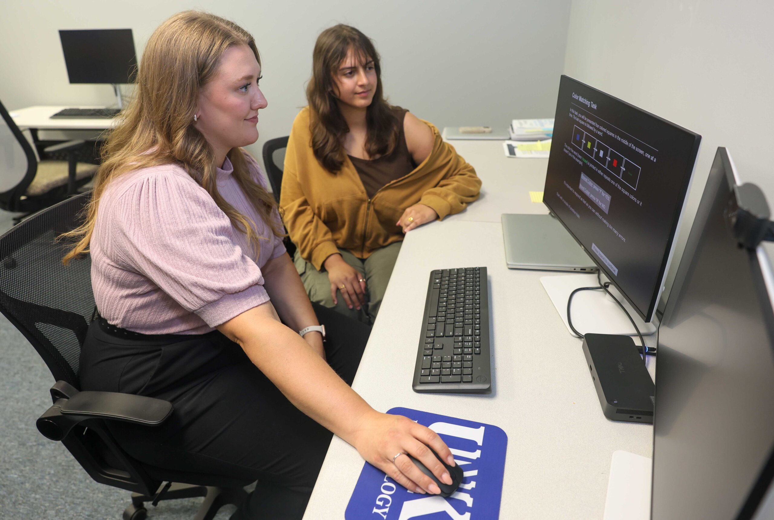 Assistant psychology professor Rachael Turner and UNK senior Blaine Tewahade work on their research project.