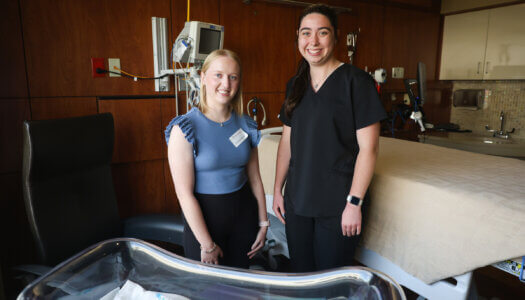 UNK students Danessa Buckles and Sarah Brott pose for a photo.