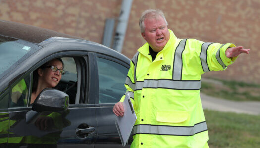 Ted Eichholz directs traffic during UNK student move-in.