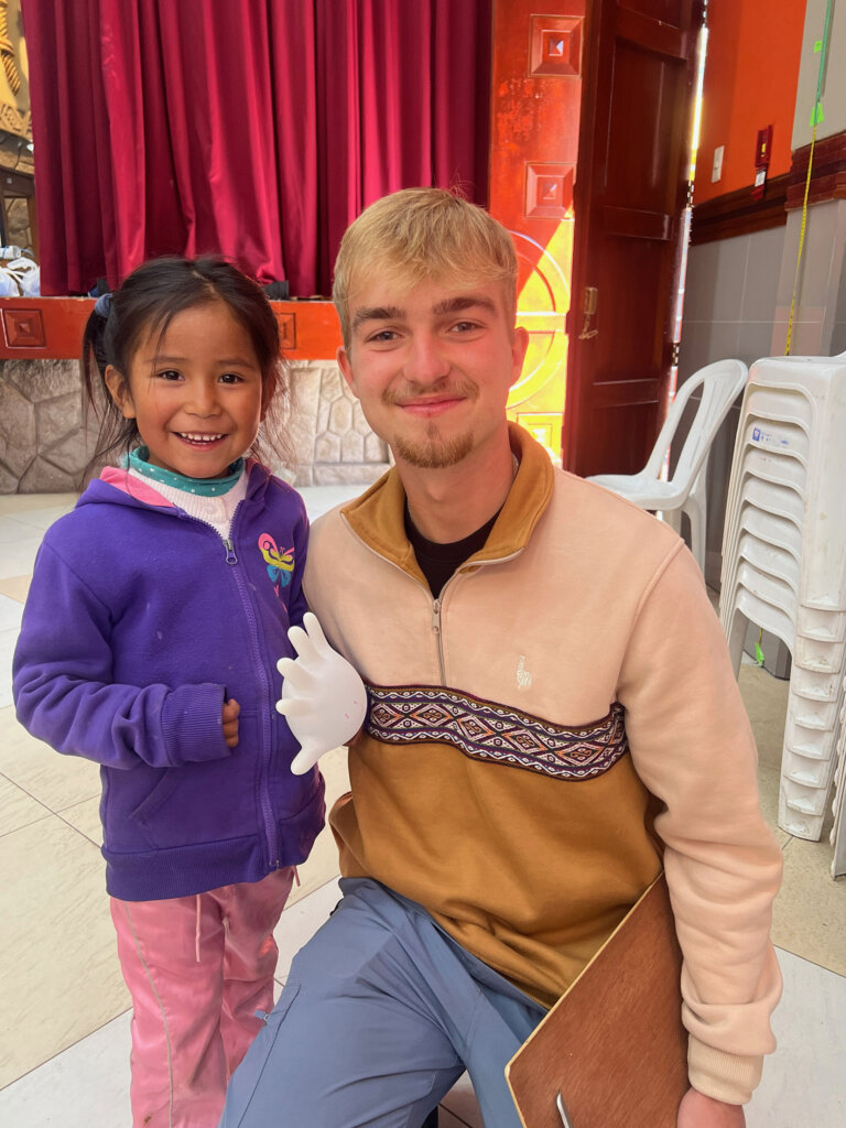 Brody Eberle poses for a photo with a young girl in Peru.