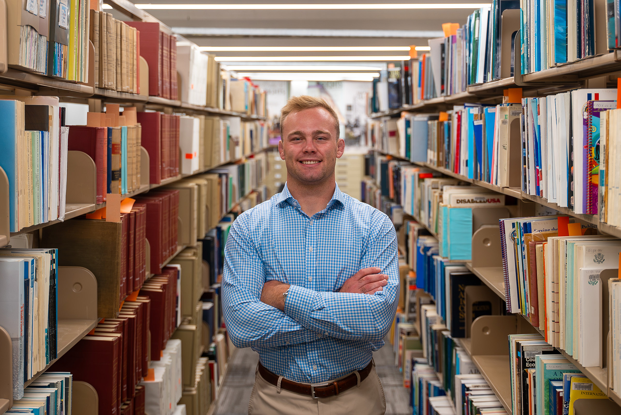 Gavyn Brauer poses for a photo in the UNK library.