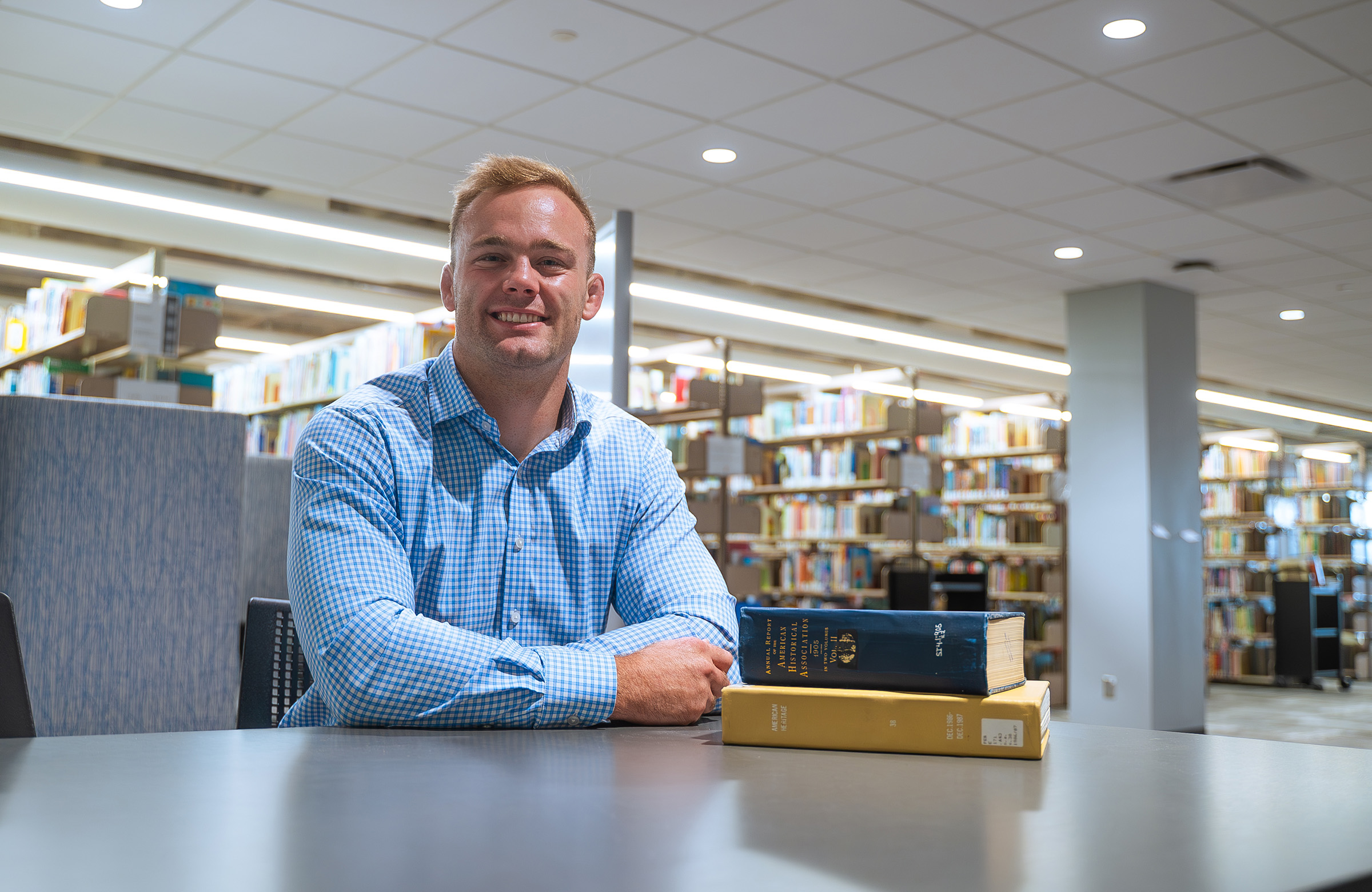 Gavyn Brauer poses for a photo in the UNK library.