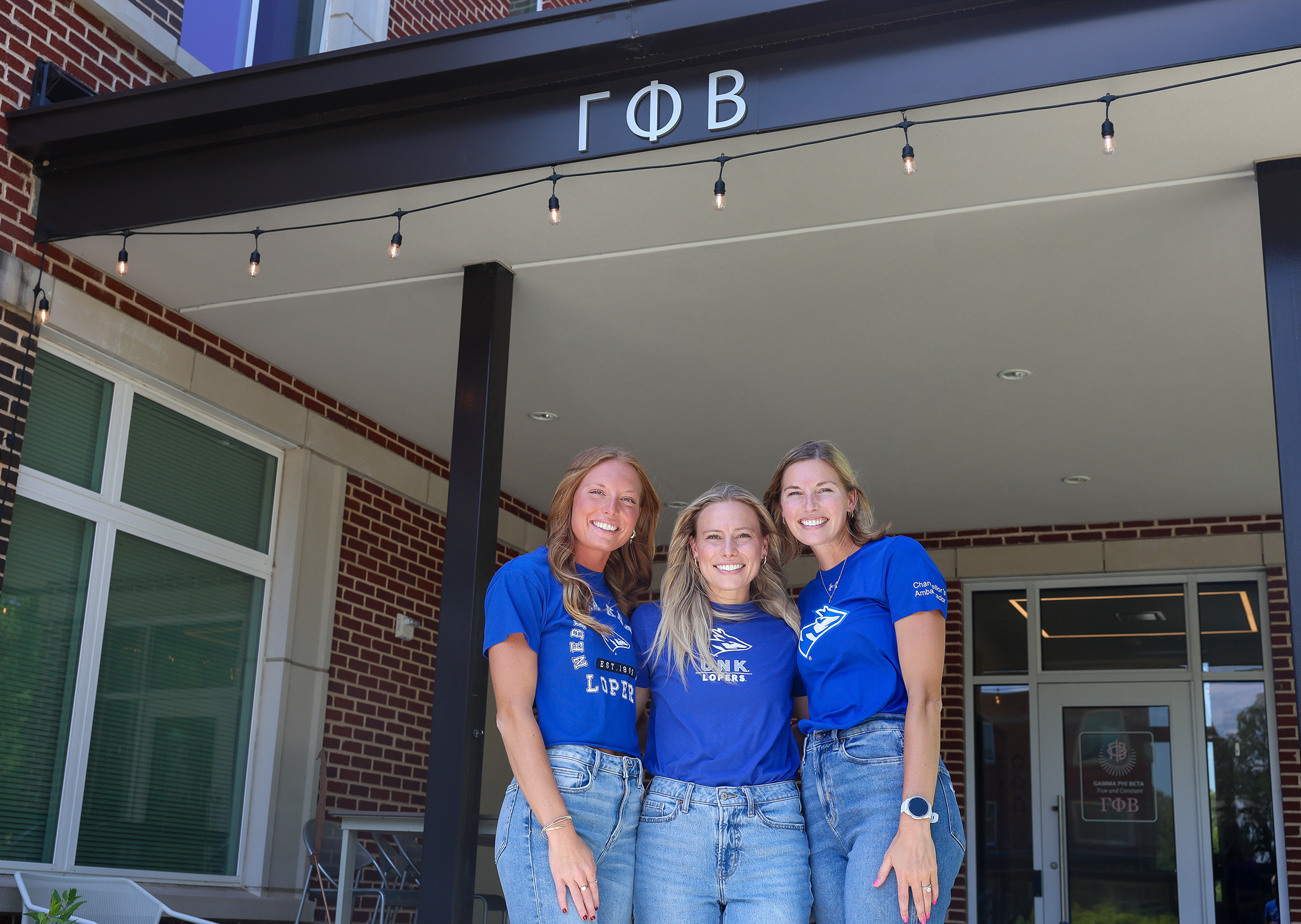Jenna Rauert, Jessica (Rauert) Huston and Jocelyn (Rauert) Childers are pictured in front of the Gamma Phi Beta house at UNK.