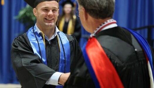 Professor Peter Longo congratulates Gavyn Brauer.