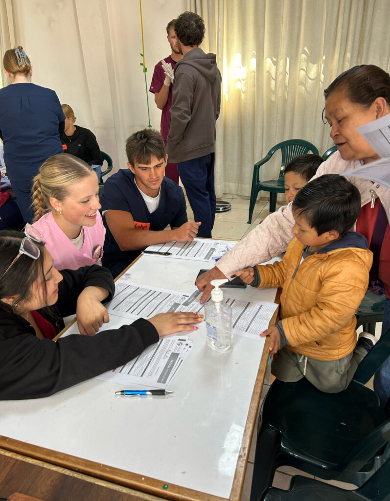 UNK students assist at a mobile medical clinic during a recent outreach trip to Peru.