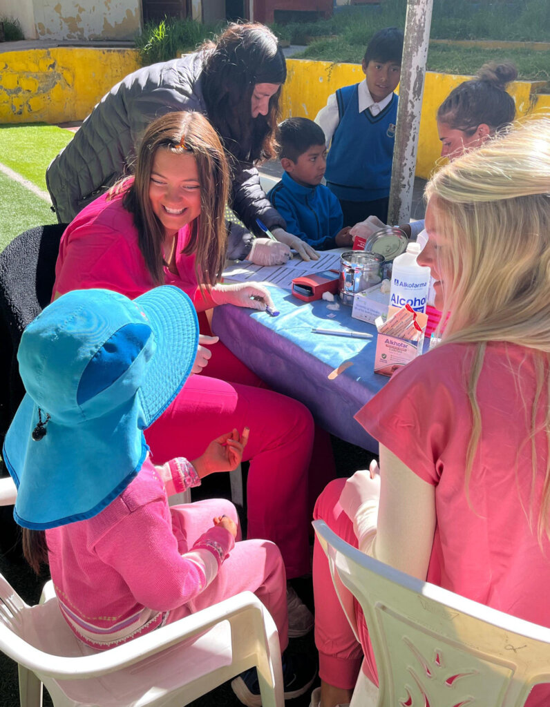 UNK students assist at a mobile medical clinic during a recent outreach trip to Peru.