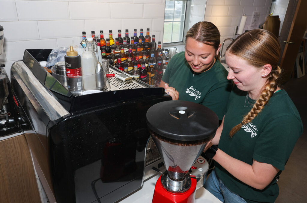 Barista’s Daily Grind employees Alison Brown and Macy Cline prepare the new UNK location for its Monday opening.