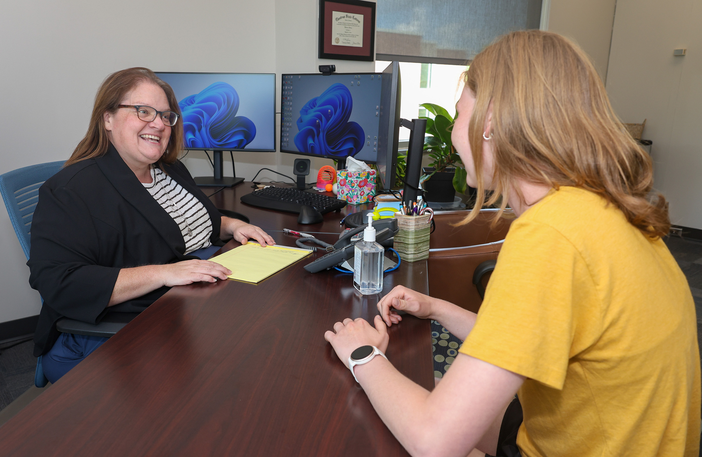 Becca Dobry meets with a student in her office at UNK.