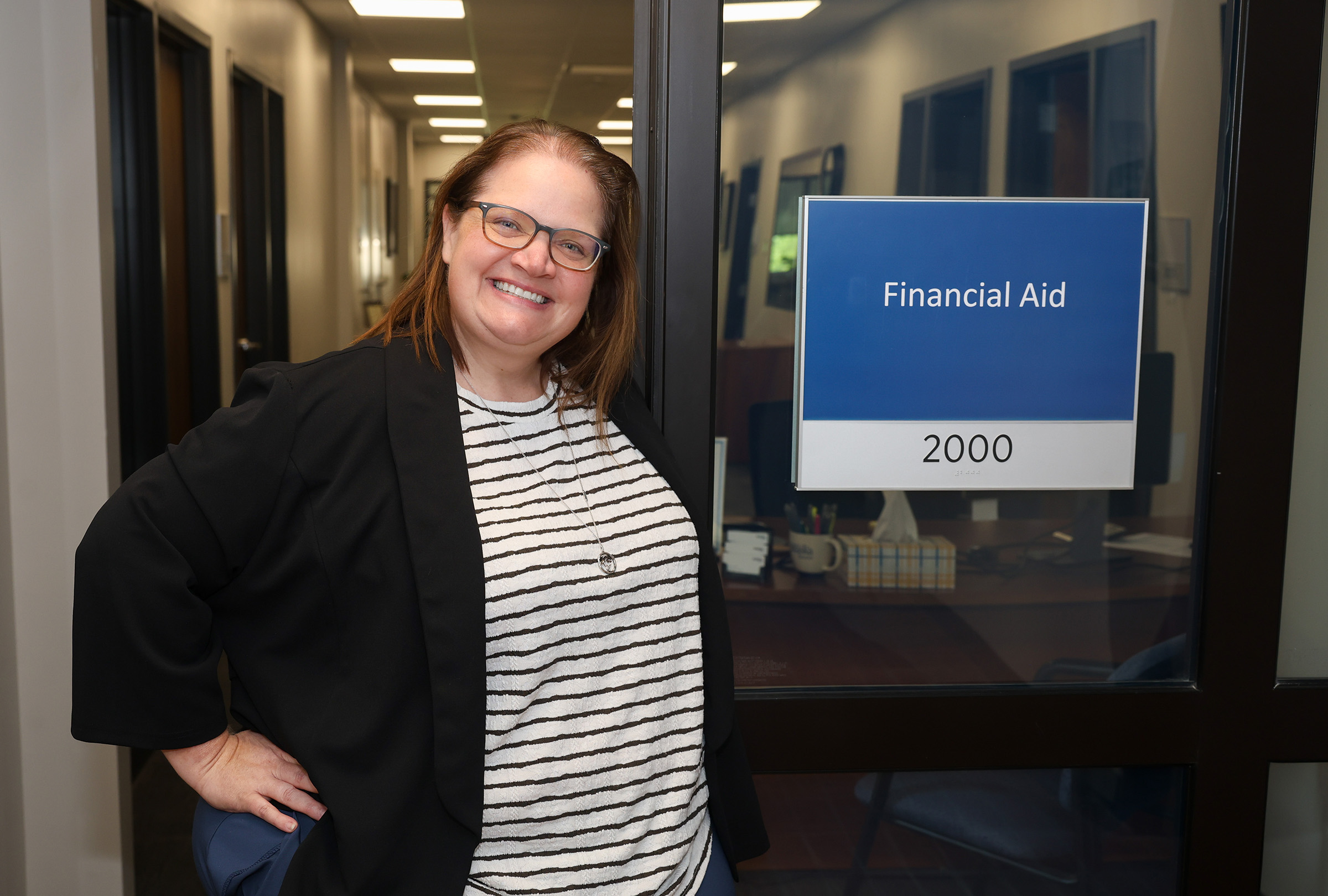 Becca Dobry poses for a photo outside the UNK Financial Aid Office.