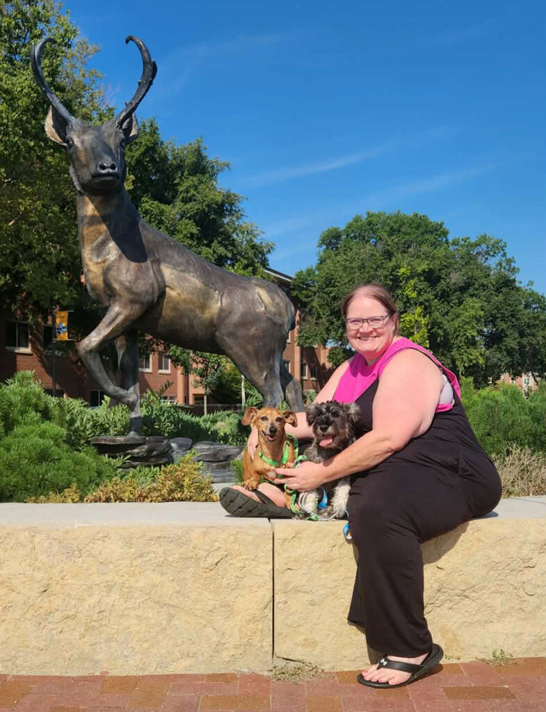 Becca Dobry is pictured with her dogs on the UNK campus.