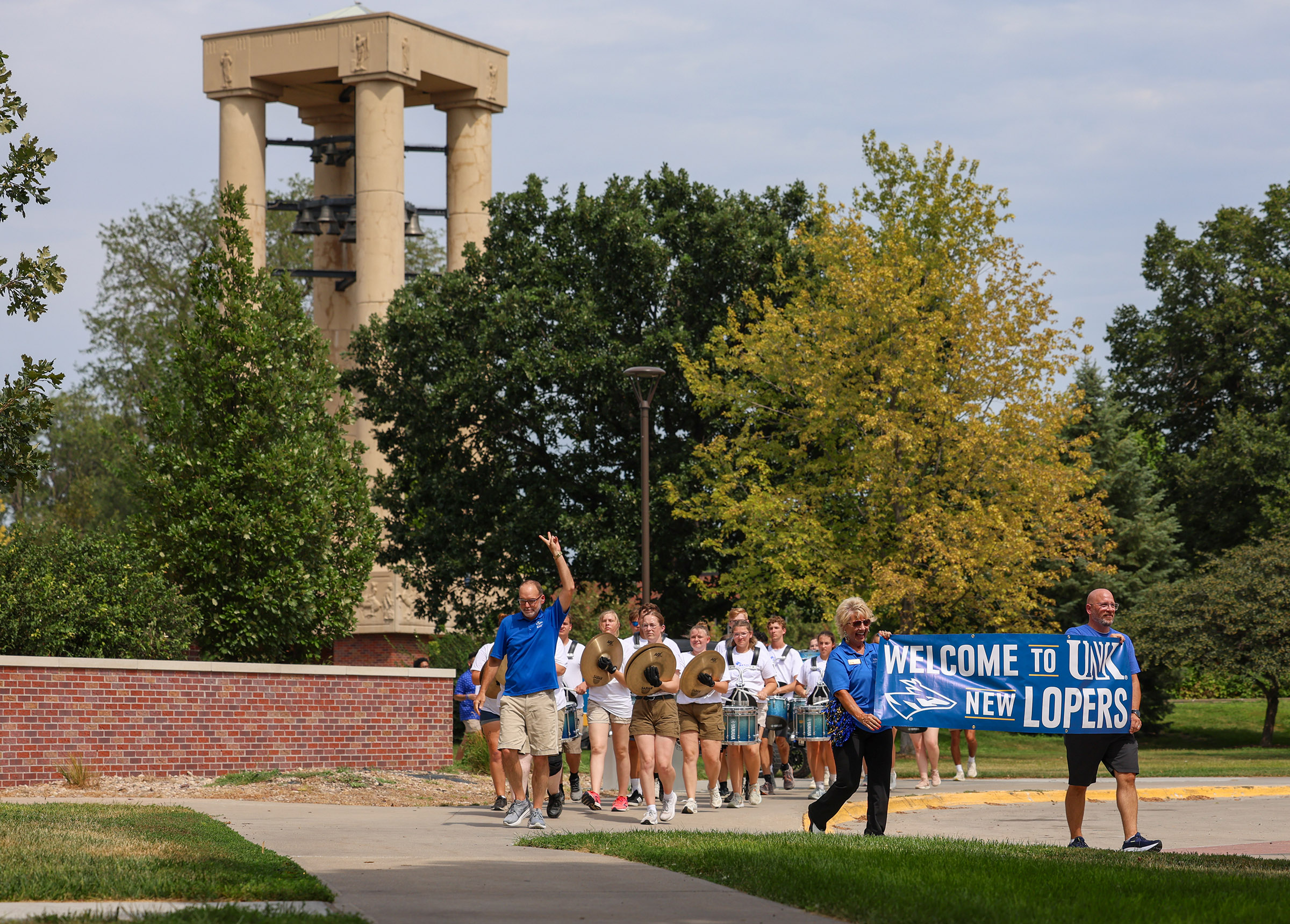 The UNK marching band leads the Parade of Lopers on campus.