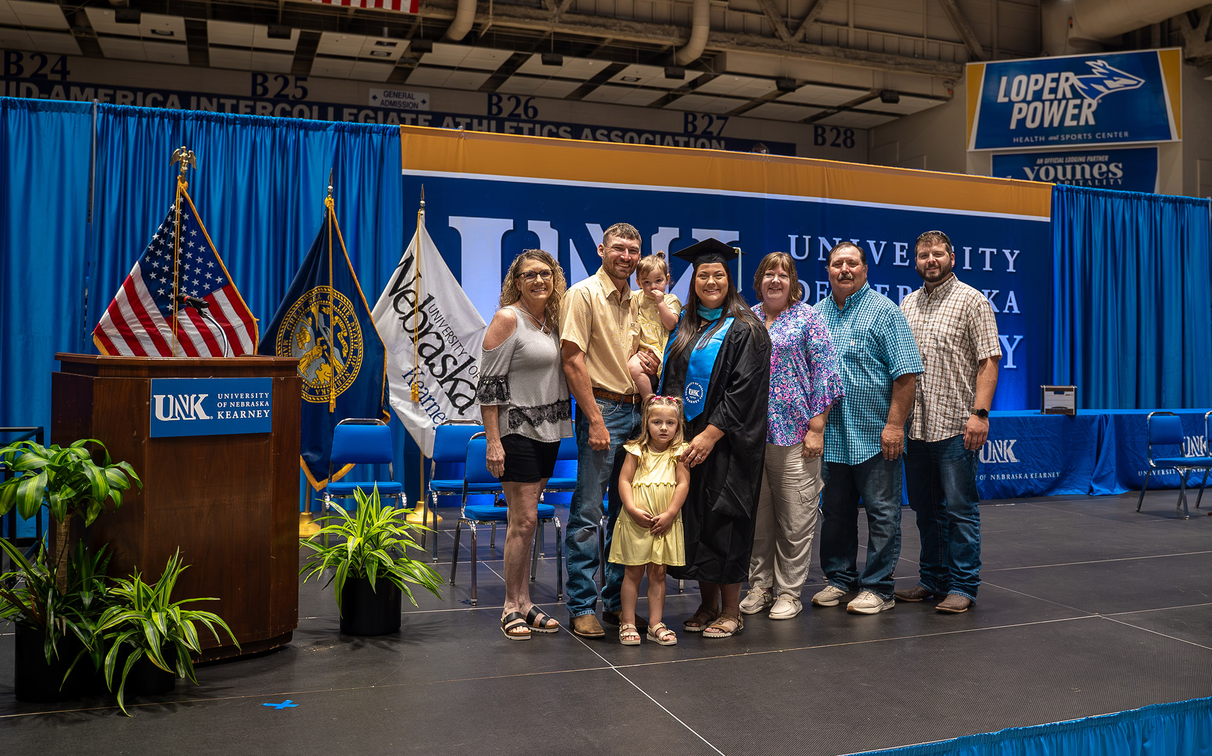 Cheyenne Fitzgerald poses for a photo with her family following Friday’s summer commencement ceremony at UNK.