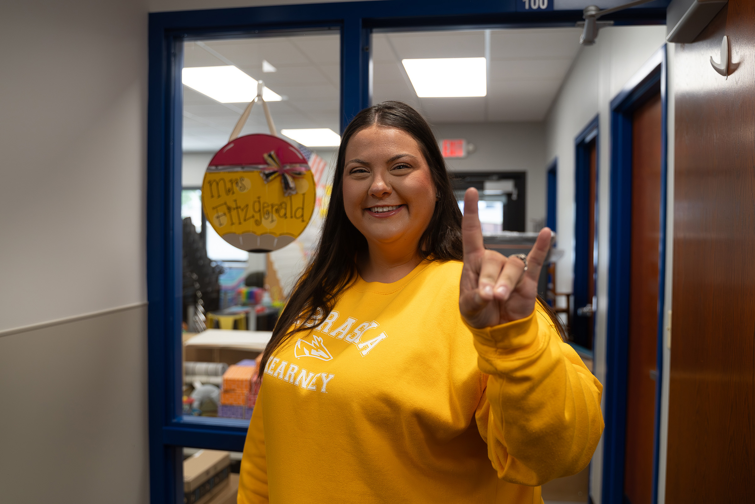 Cheyenne Fitzgerald poses for a photo outside her preschool classroom.