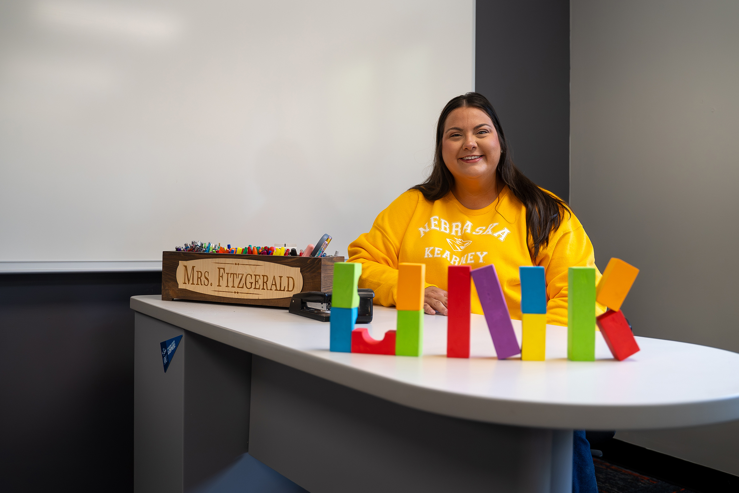 Cheyenne Fitzgerald poses for a photo inside her preschool classroom.