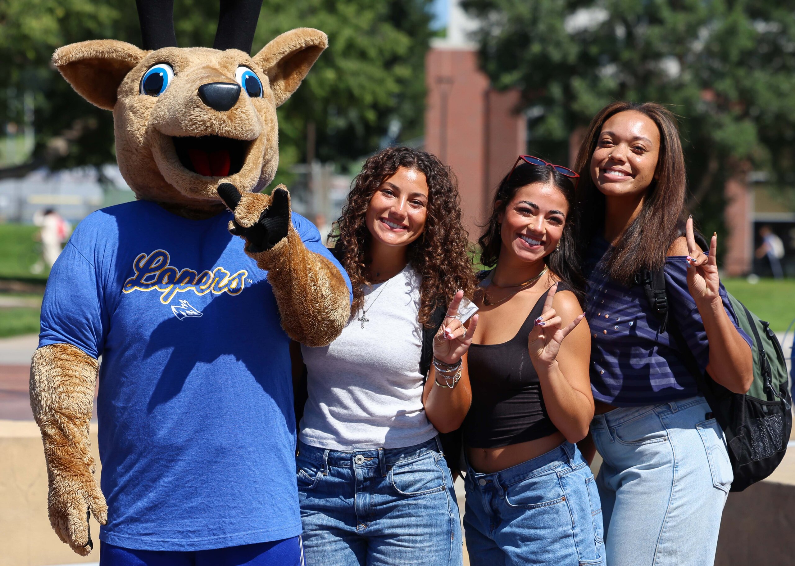 Students throw their Lopes with Louie the Loper, the UNK mascot.