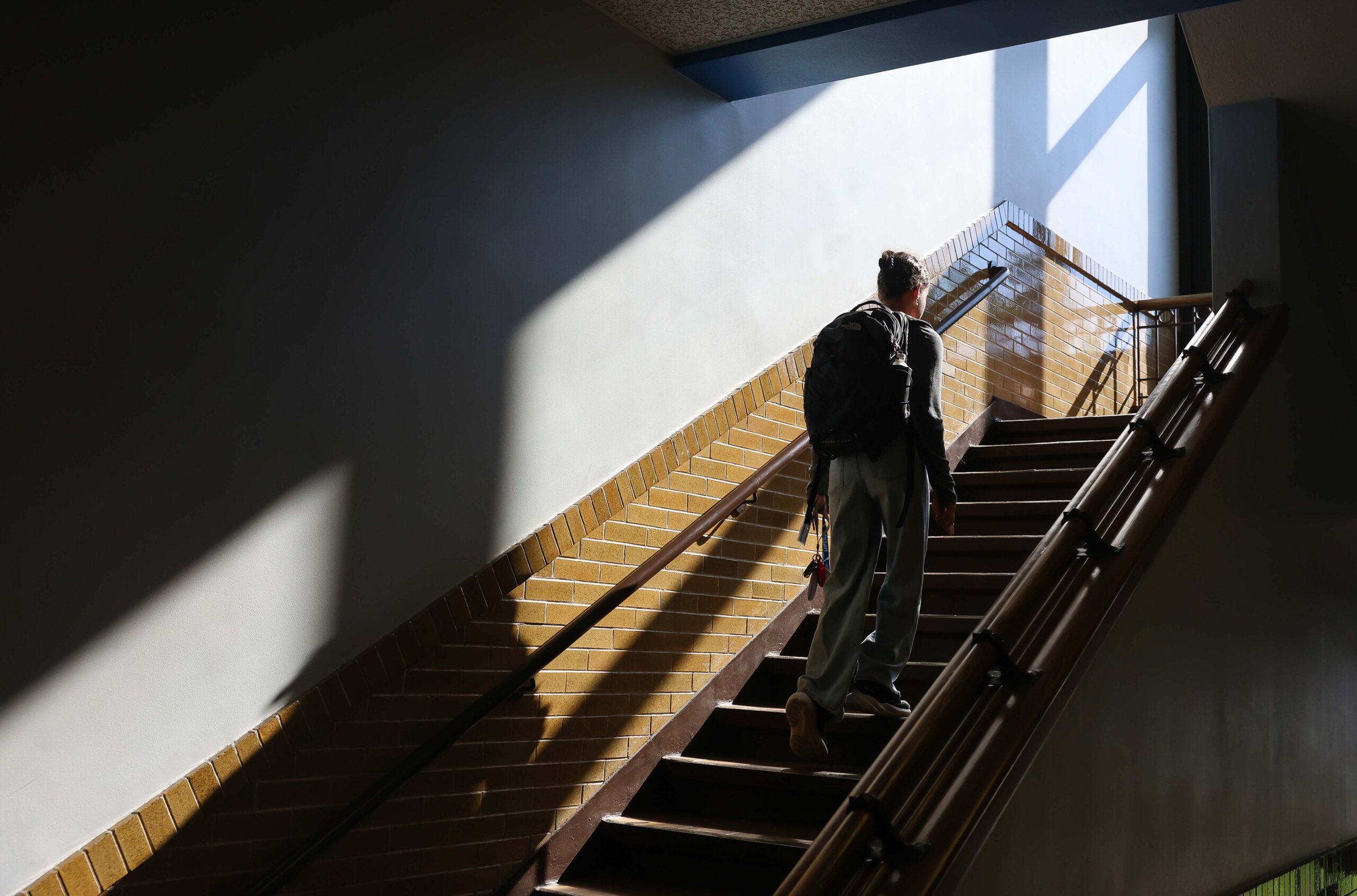 A student walks up stairs.