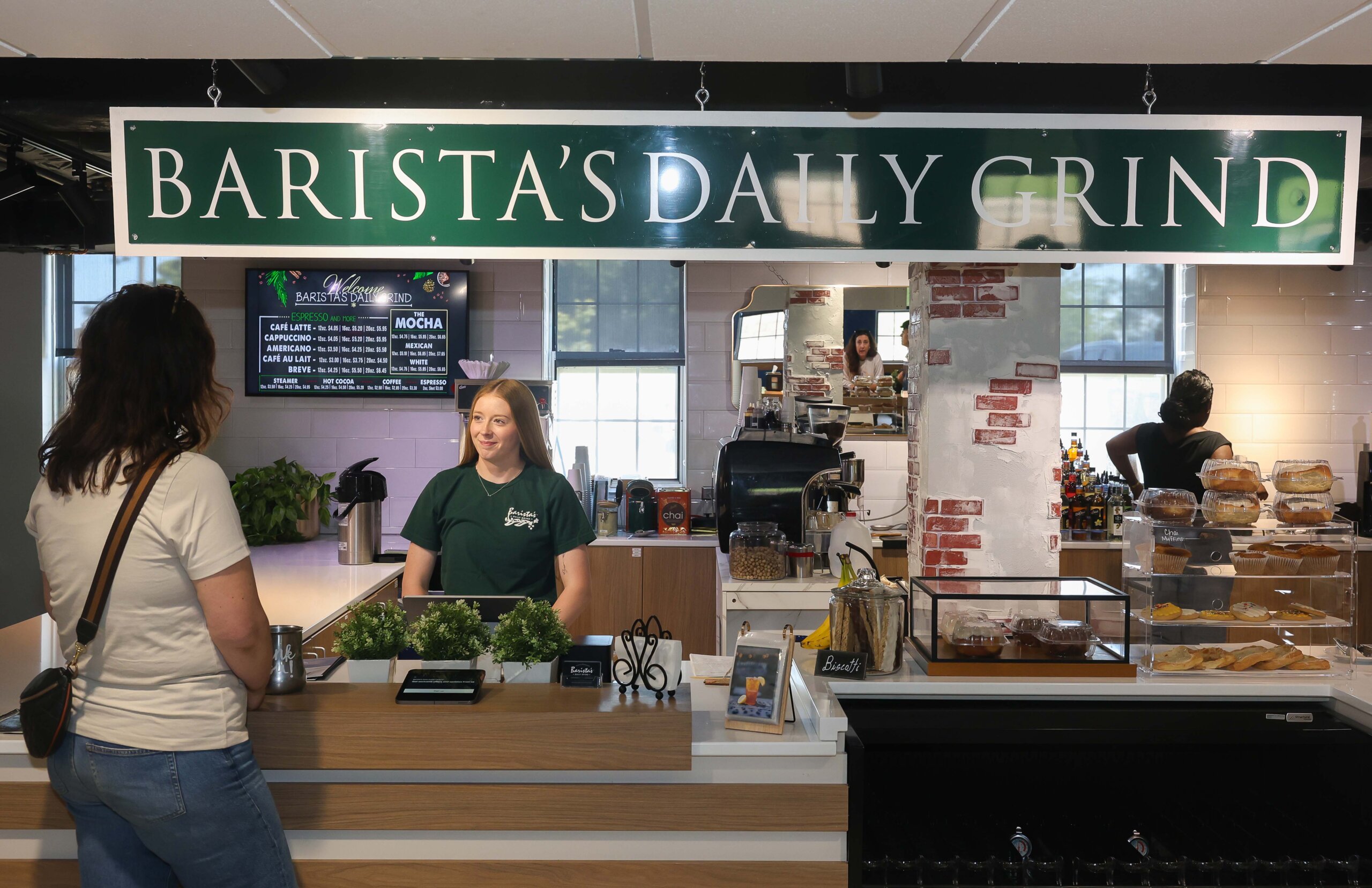 A woman orders at a coffee shop.