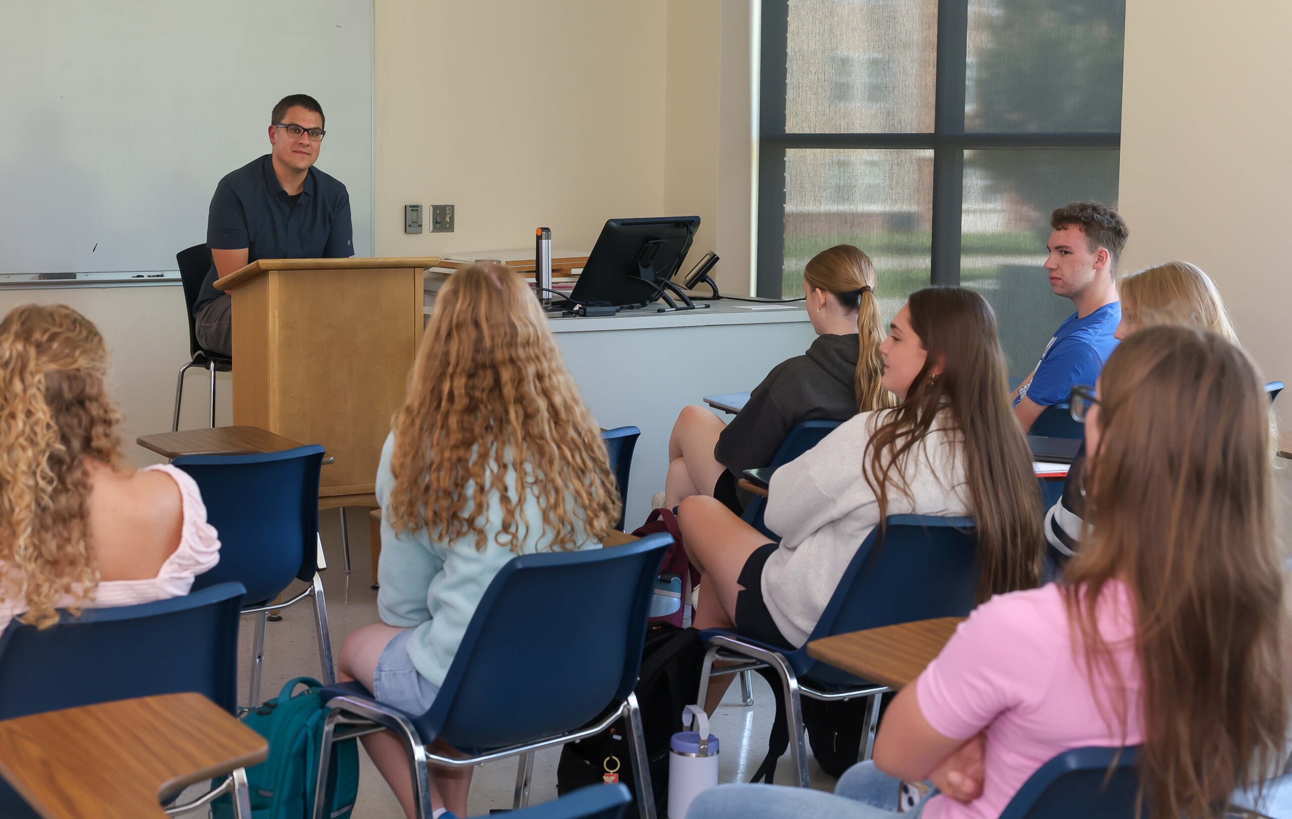 A professor and students in a classroom.